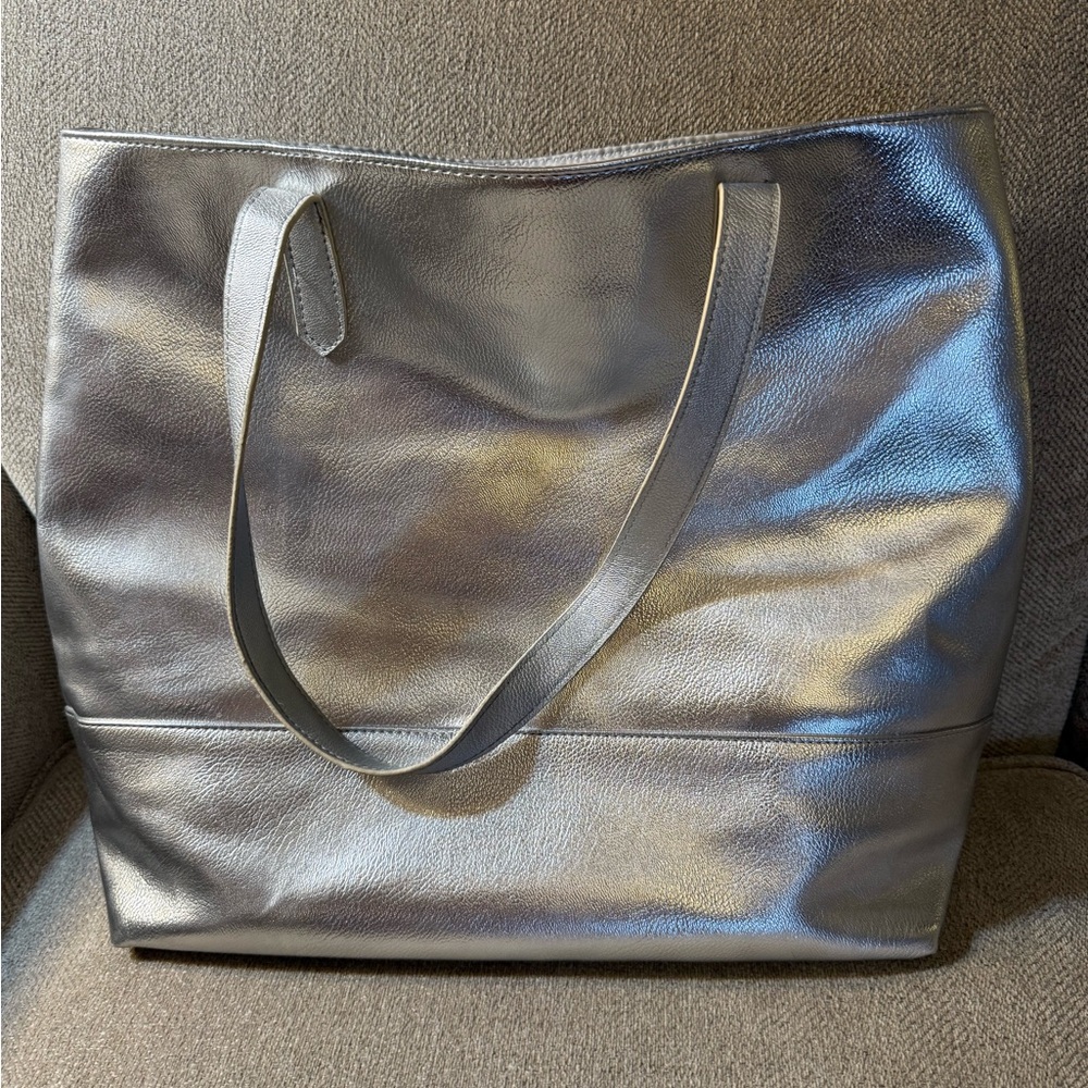 Bloomingdale’s silver tote bag. 16” width by 13” height.